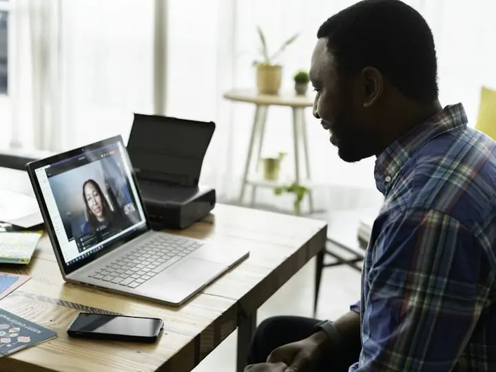 A salesman on a video call at his laptop