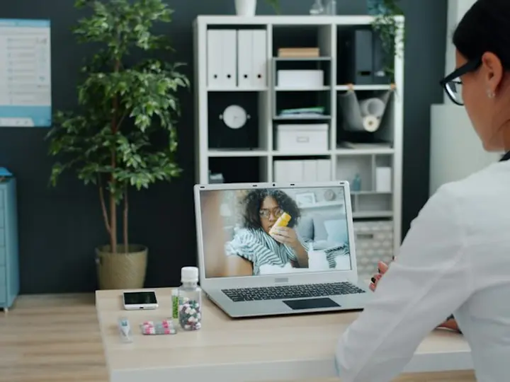 A doctor talking to a patient over video